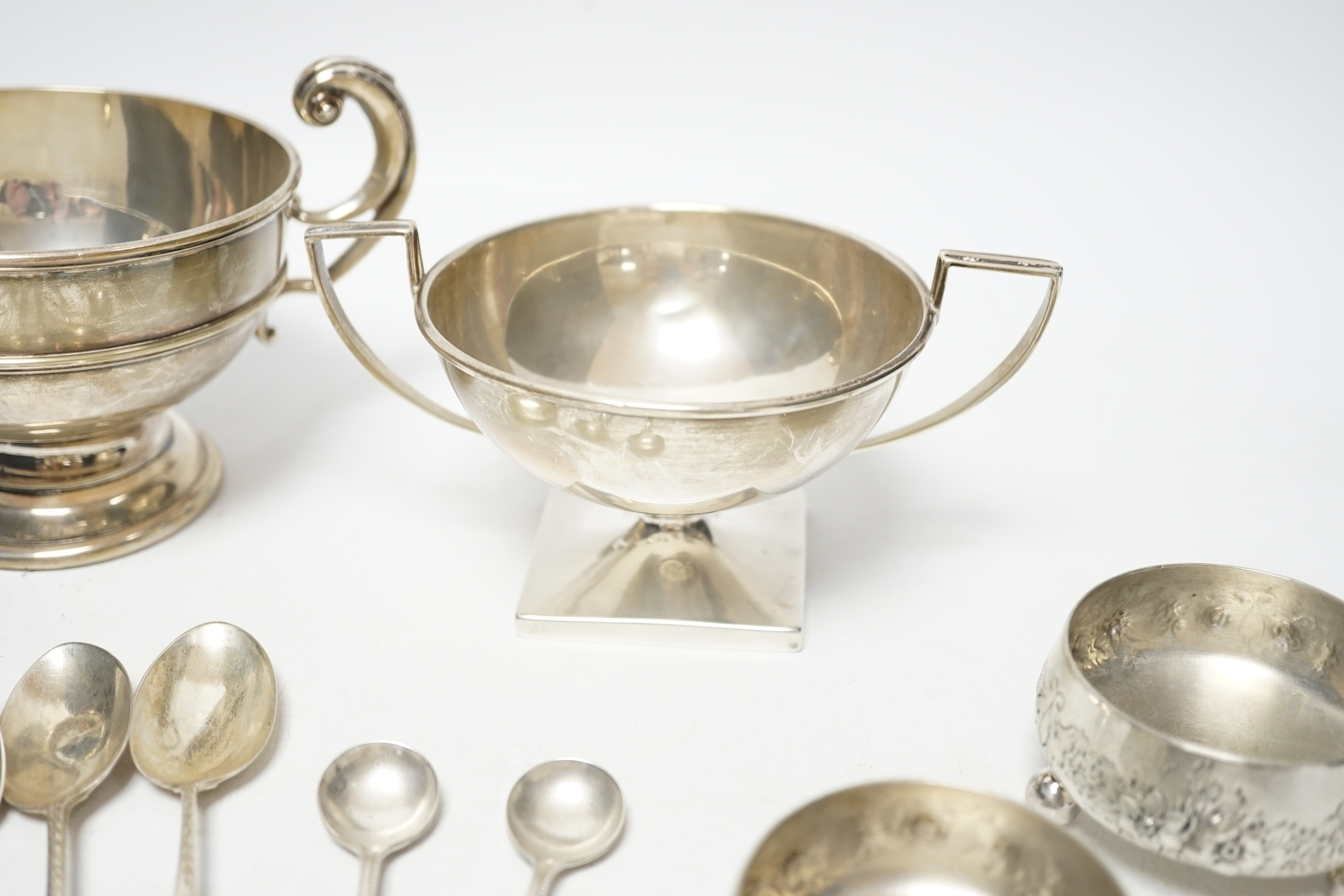 An Edwardian silver two handled bowl, Chester, 1902, diameter 10.4cm, a sterling bowl, a pair of engraved silver tub salts and matching salt spoons, Mappin & Webb, Sheffield, 1908 and a set of five silver teaspoons.